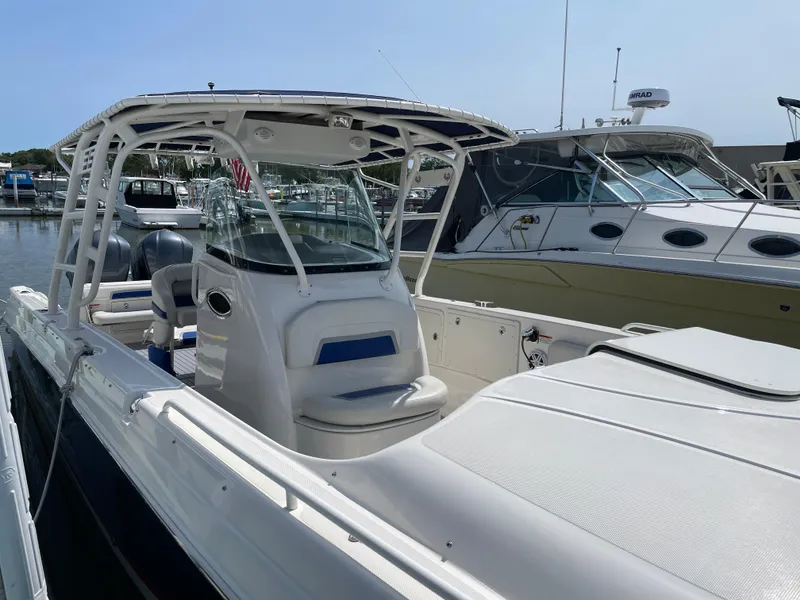 Slide: The Image of 2015 Wellcraft 35 Scarab boat docked at marina, featuring sleek design and spacious deck. - 8