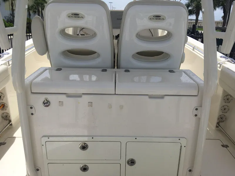 Slide: The Image of 2017 Cobia 296 CC boat interior with dual seats and storage compartments. - 16