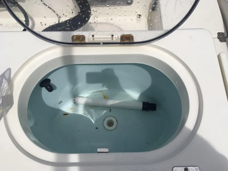 Slide: The Image of Livewell on 2017 Cobia 296 CC boat, open lid, interior view. - 18