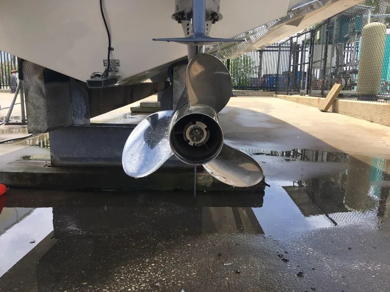 Slide: The Image of Close-up of a 2017 Cobia 296 CC boat propeller in a marina setting. - 22