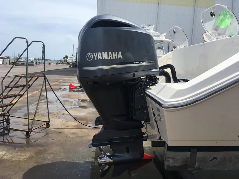 Slide: The Image of 2017 Cobia 296 CC boat with Yamaha outboard motor at dockside. - 23