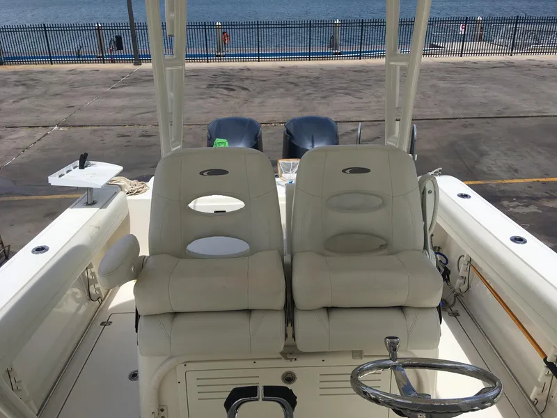 Slide: The Image of 2017 Cobia 296 CC boat interior with dual seats and steering wheel. - 5