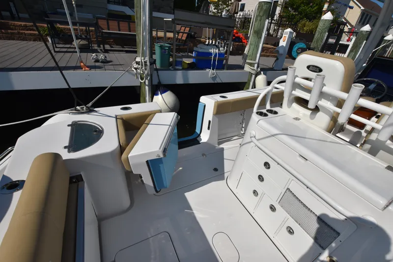 Slide: The Image of 2016 Sportsman Open 312 Center Console boat interior with seating and storage compartments. - 10