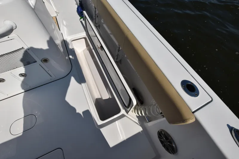 Slide: The Image of 2016 Sportsman Open 312 Center Console boat deck with storage compartment and seating. - 11