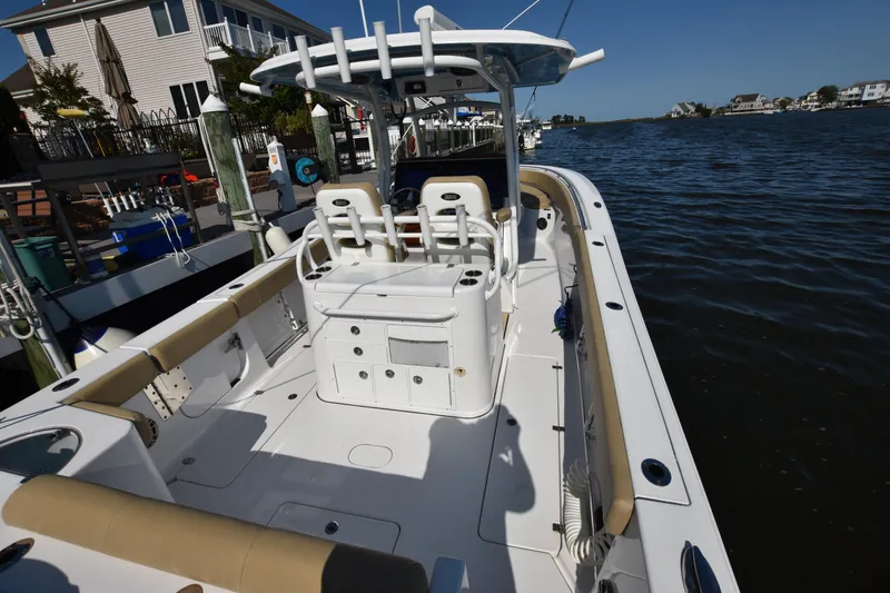 Slide: The Image of 2016 Sportsman Open 312 Center Console boat docked by waterfront homes. - 12
