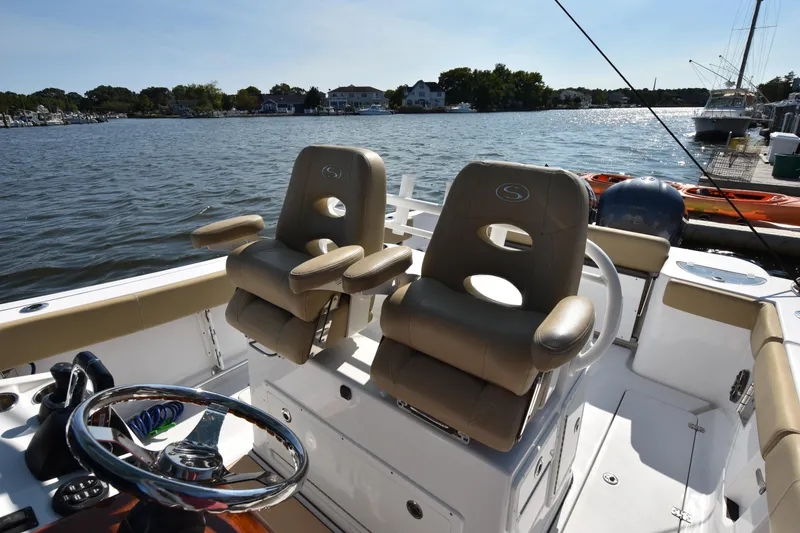 Slide: The Image of 2016 Sportsman Open 312 Center Console boat interior with dual captain's chairs. - 14