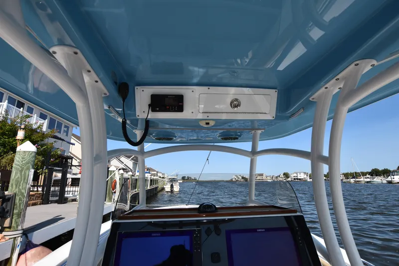 Slide: The Image of 2016 Sportsman Open 312 Center Console boat interior with navigation screens and waterfront view. - 17
