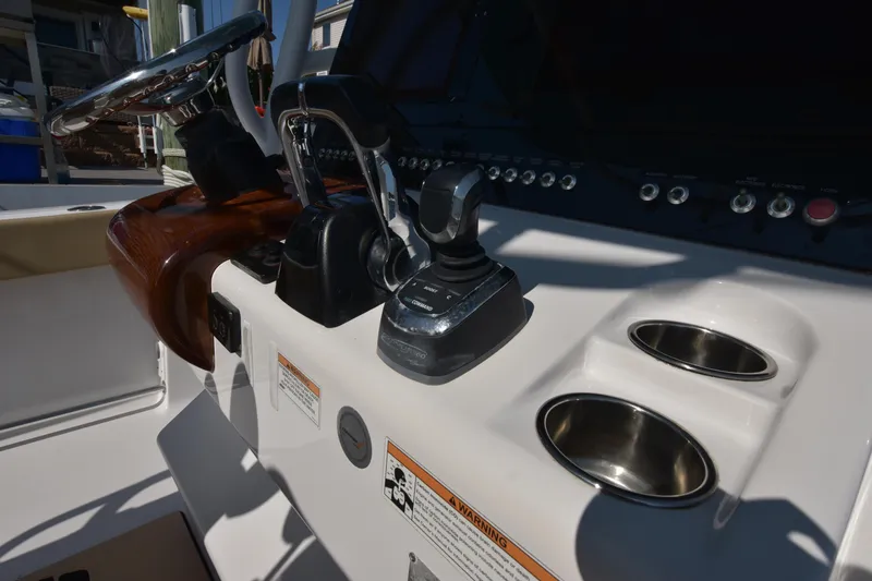 Slide: The Image of 2016 Sportsman Open 312 Center Console dashboard with controls and cup holders. - 18
