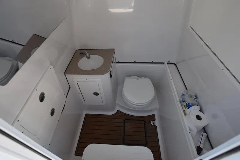 Slide: The Image of 2016 Sportsman Open 312 Center Console boat bathroom with sink and toilet. - 21