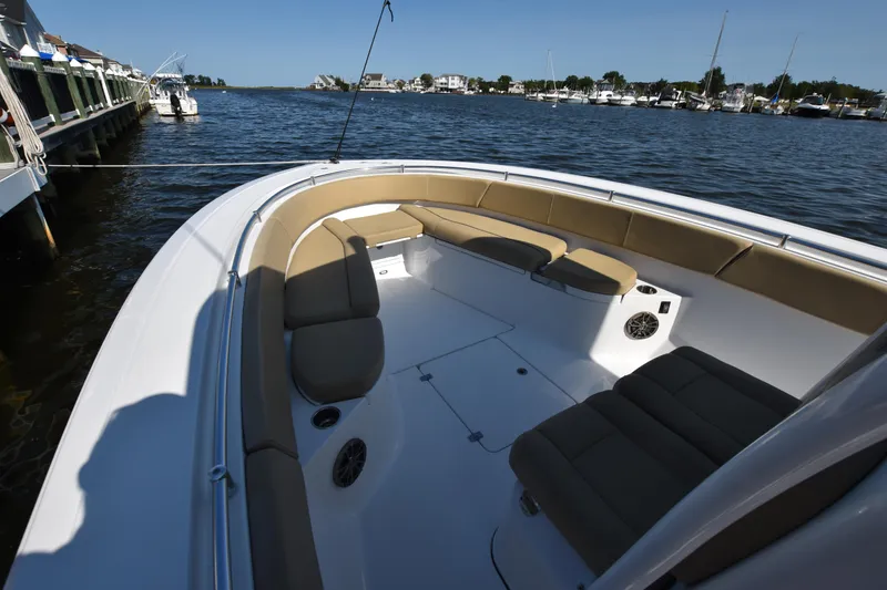 Slide: The Image of 2016 Sportsman Open 312 Center Console boat with spacious seating, docked by a marina. - 22