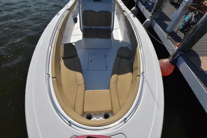 Slide: The Image of 2016 Sportsman Open 312 Center Console boat with tan seating, docked by the water. - 24
