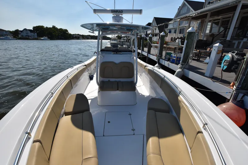 Slide: The Image of 2016 Sportsman Open 312 Center Console boat docked by waterfront homes. - 25