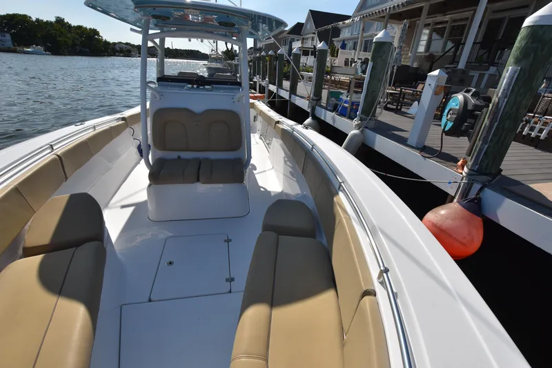 Slide: The Image of 2016 Sportsman Open 312 Center Console boat docked by waterfront homes. - 26