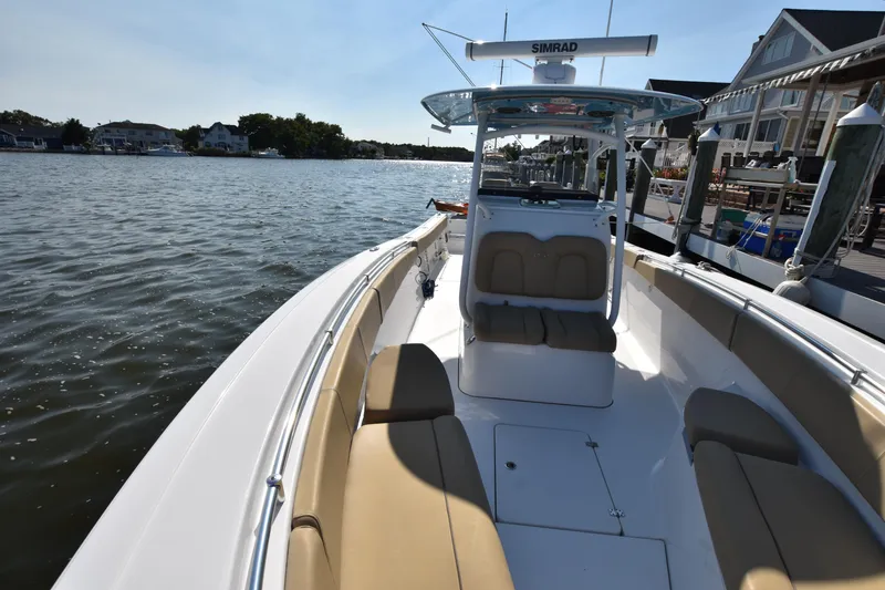 Slide: The Image of 2016 Sportsman Open 312 Center Console boat docked by waterfront homes. - 27