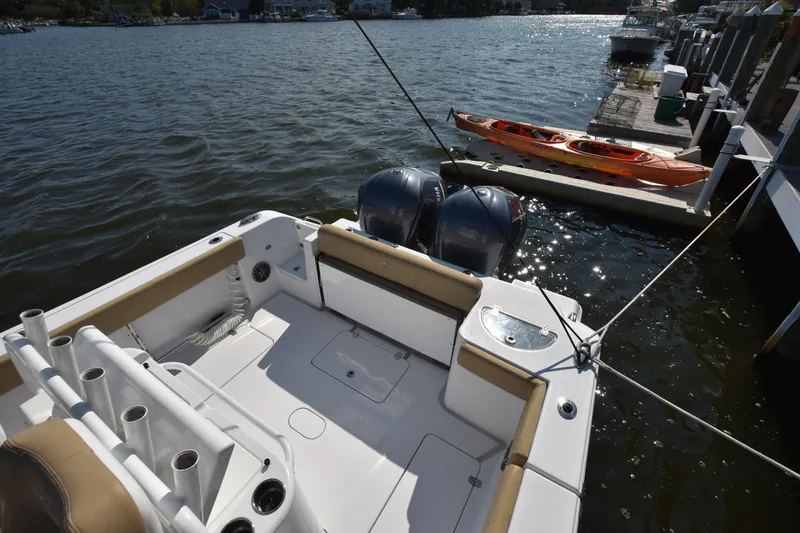 Slide: The Image of 2016 Sportsman Open 312 Center Console boat docked by the water. - 3
