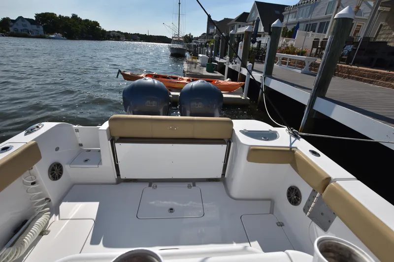 Slide: The Image of 2016 Sportsman Open 312 Center Console boat docked by waterfront homes. - 6