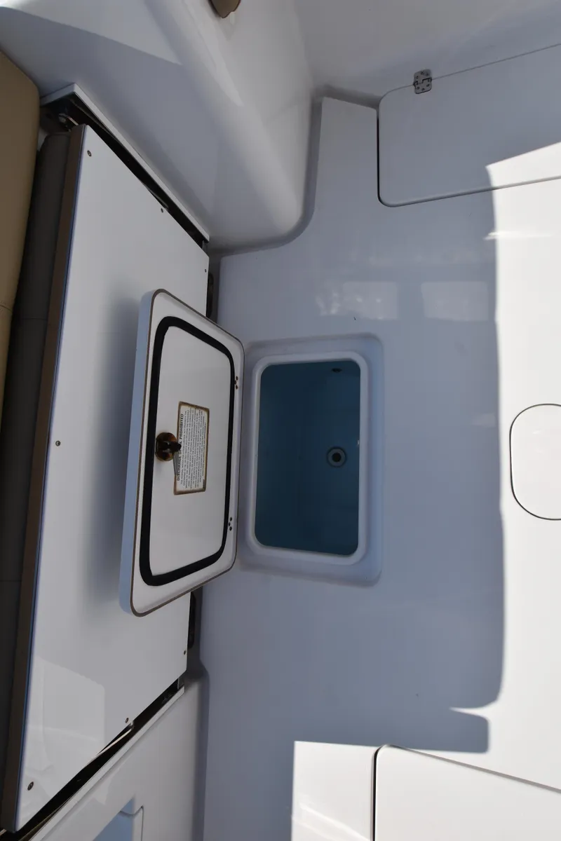 Slide: The Image of 2016 Sportsman Open 312 Center Console interior storage compartment. - 8