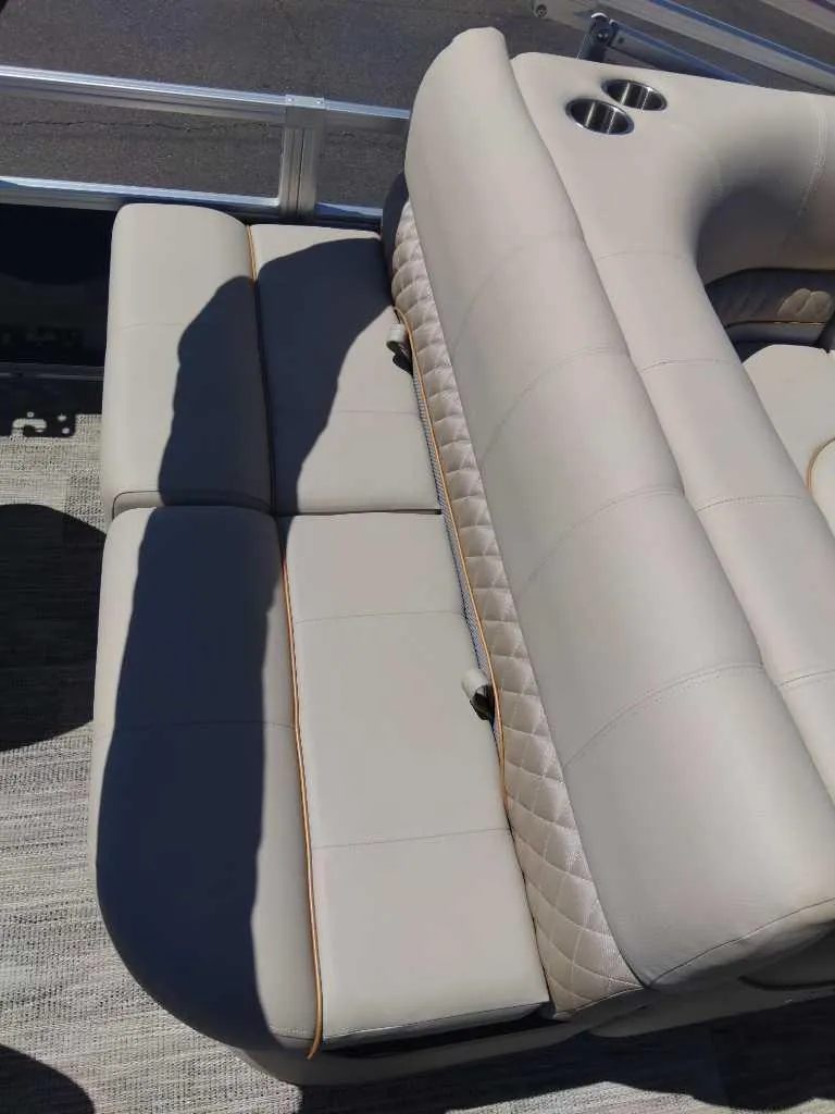 Slide: The Image of 2024 Ranger Reata 223F boat seating with beige upholstery and cup holders. - 4