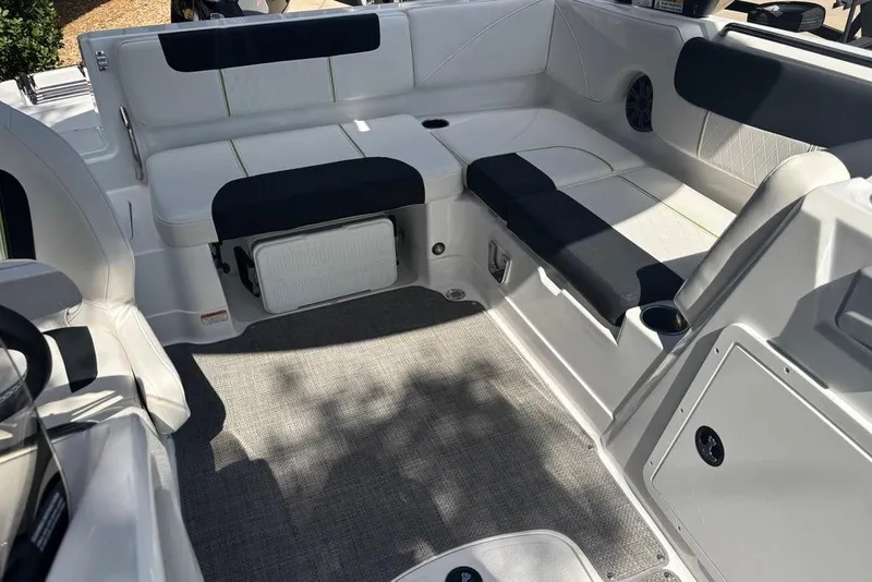 Slide: The Image of Interior of 2024 Tahoe 1950 boat with white and black seating, carpeted floor. - 11