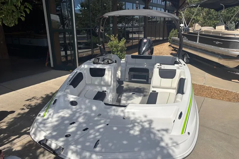 Slide: The Image of 2024 Tahoe 1950 boat with sleek design, parked outdoors in sunlight. - 3