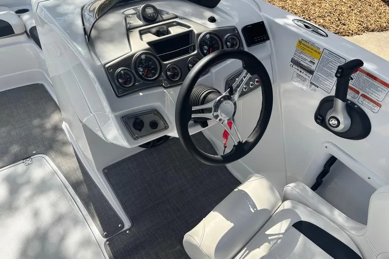 Slide: The Image of Cockpit of 2024 Tahoe 1950 boat featuring steering wheel and control panel. - 9