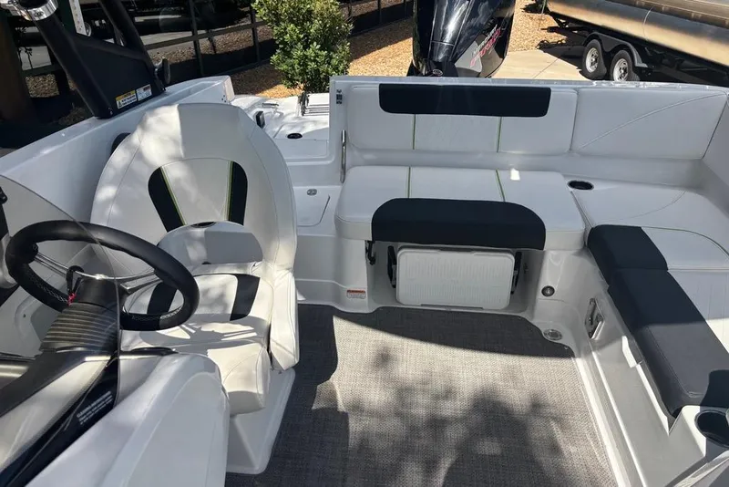 Slide: The Image of Interior of a 2024 Tahoe 1950 boat featuring seating and steering wheel. - 12