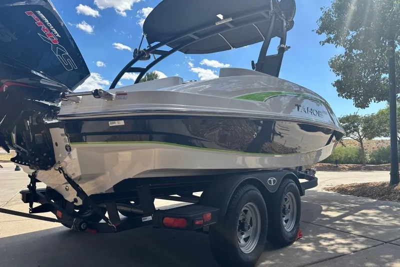 Slide: The Image of 2024 Tahoe 1950 boat on trailer, featuring sleek design and powerful engine. - 13