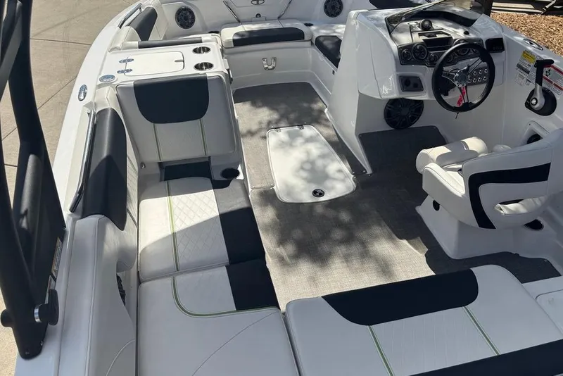 Slide: The Image of 2024 Tahoe 1950 boat interior with modern seating and steering console. - 8