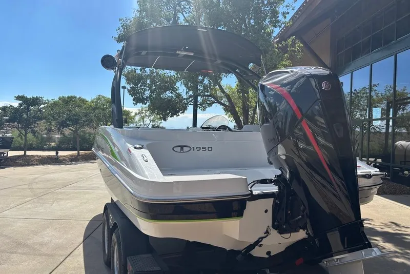 Slide: The Image of 2024 Tahoe 1950 boat with powerful outboard motor, parked outdoors on a sunny day. - 15
