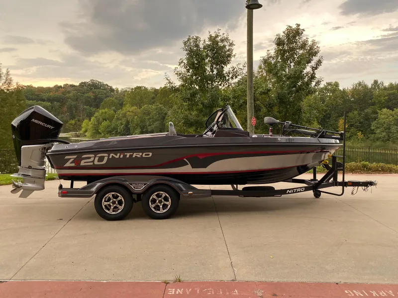 The Image of 2024 Nitro ZV20 Pro boat on trailer, parked outdoors with trees in background. - 0