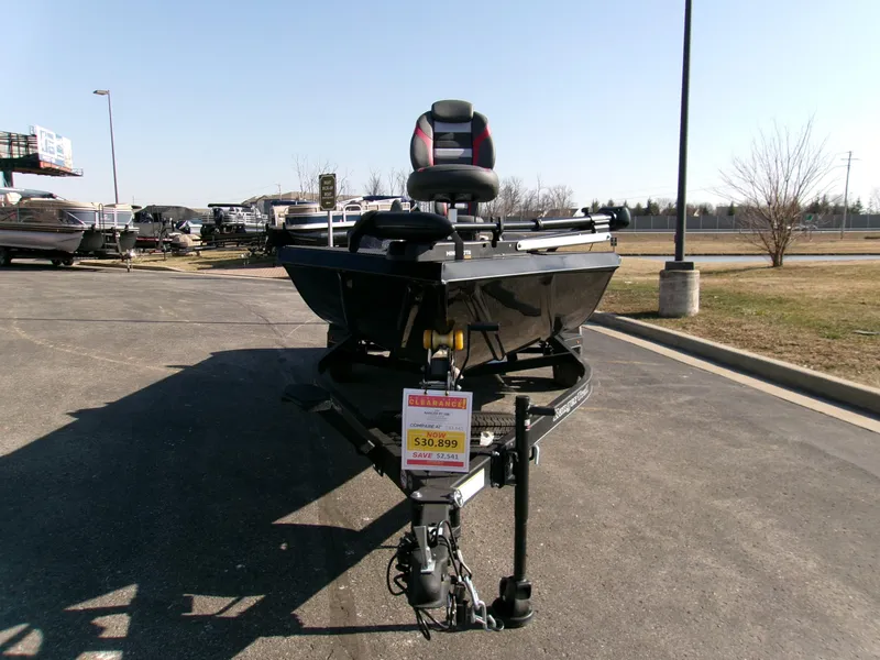Slide: The Image of 2024 Ranger RT188 boat on display in a parking lot. - 2