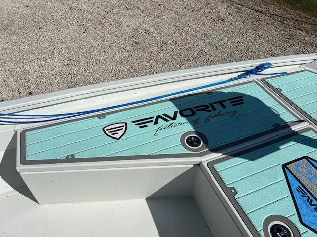 Slide: The Image of Lowe Bay 22 boat deck, 2022 model, with "Favorite" branding and blue rope. - 10