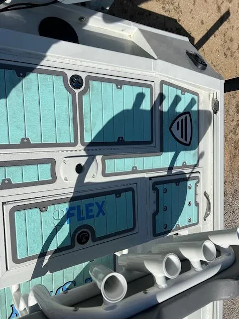 Slide: The Image of 2022 Lowe Bay 22 boat deck with teal panels and rod holders. - 2