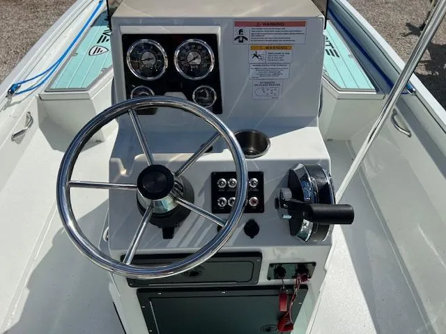 Slide: The Image of 2022 Lowe Bay 22 boat console with steering wheel and controls. - 5