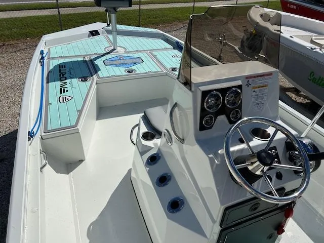Slide: The Image of 2022 Lowe Bay 22 boat interior with steering console and seating. - 7