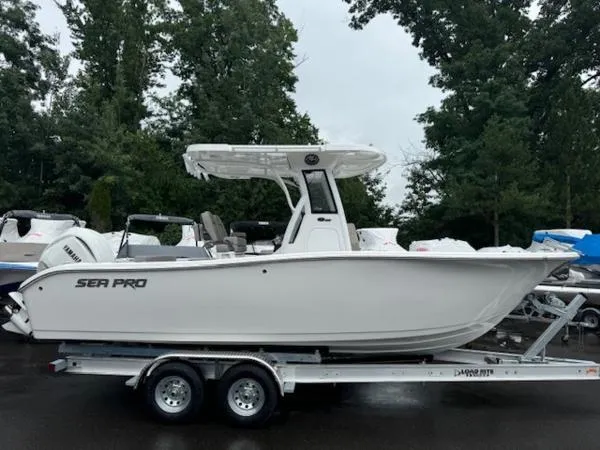 Slide: The Image of 2025 Sea Pro 242 Center Console boat on trailer, parked outdoors. - 0
