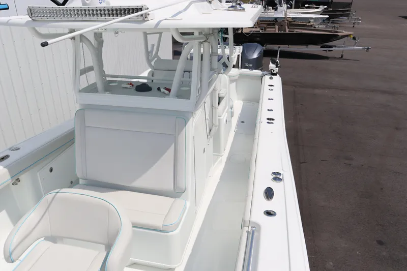 Slide: The Image of 2018 Yellowfin 36 Offshore boat, white interior, docked on a sunny day. - 10