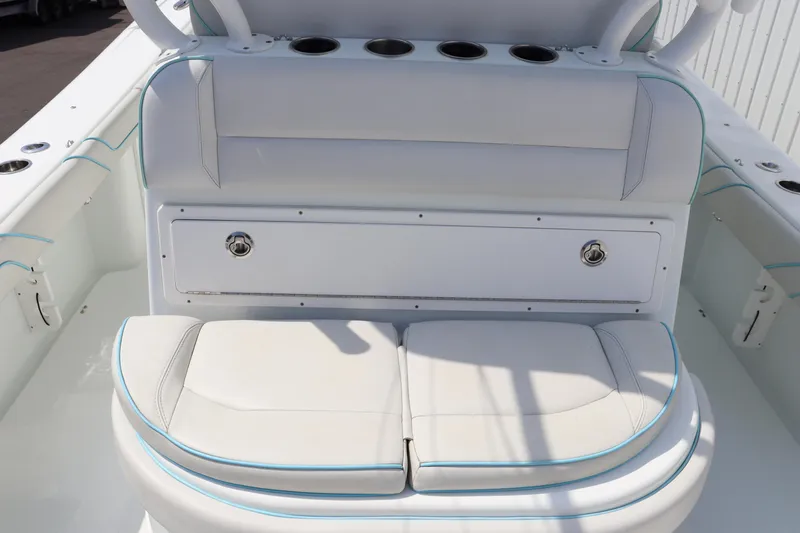 Slide: The Image of 2018 Yellowfin 36 Offshore boat seating area with white cushions and storage. - 17