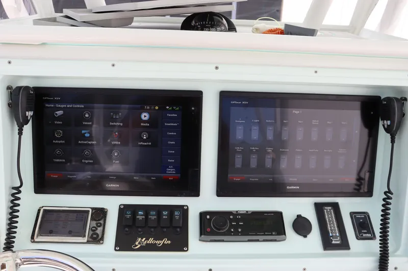 Slide: The Image of 2018 Yellowfin 36 Offshore boat dashboard with dual touchscreen displays and navigation controls. - 22