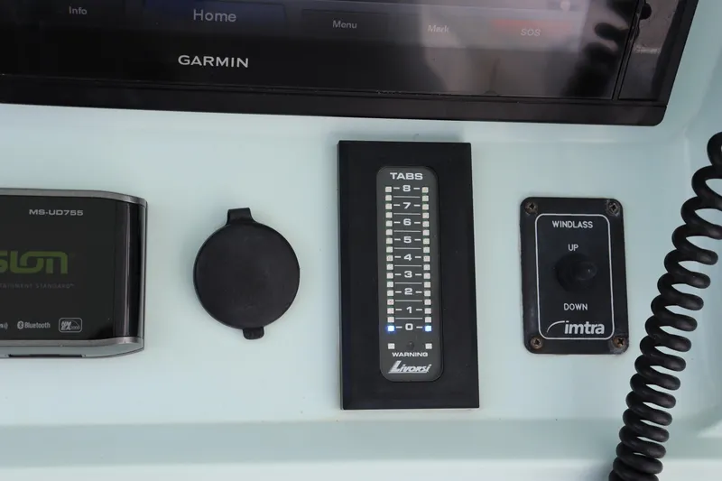 Slide: The Image of Control panel of a 2018 Yellowfin 36 Offshore boat with Garmin display and trim tabs. - 24