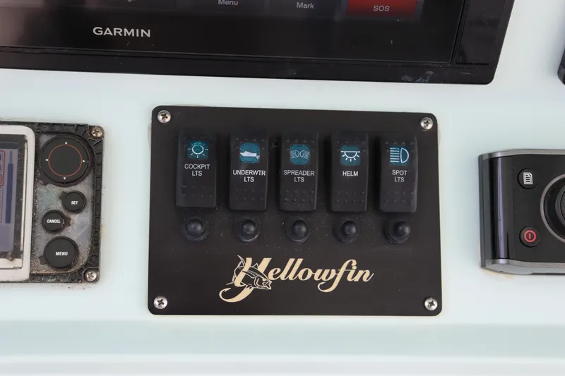 Slide: The Image of Control panel of a 2018 Yellowfin 36 Offshore boat with labeled switches. - 26