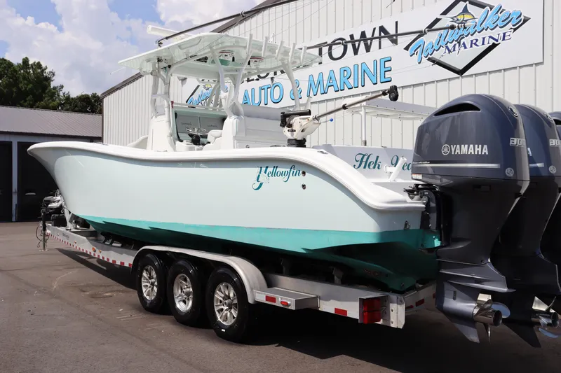Slide: The Image of 2018 Yellowfin 36 Offshore boat on trailer with Yamaha engines at a marine dealership. - 3