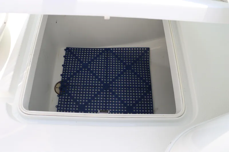 Slide: The Image of Open storage compartment on 2018 Yellowfin 36 Offshore boat with blue mat inside. - 32