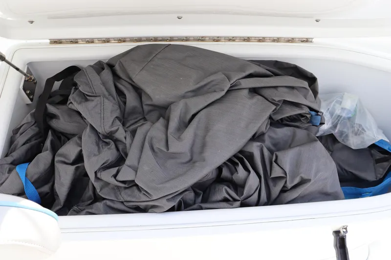 Slide: The Image of Storage compartment of 2018 Yellowfin 36 Offshore boat with gray cover inside. - 34