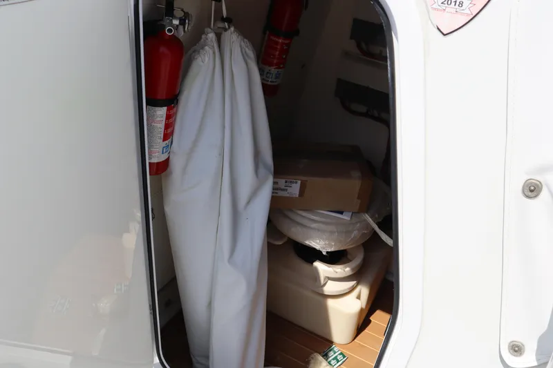 Slide: The Image of Storage compartment of 2018 Yellowfin 36 Offshore boat with fire extinguishers and equipment. - 36