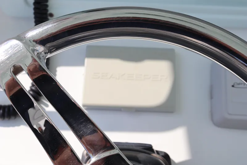 Slide: The Image of Steering wheel of 2018 Yellowfin 36 Offshore boat with Seakeeper control panel. - 41