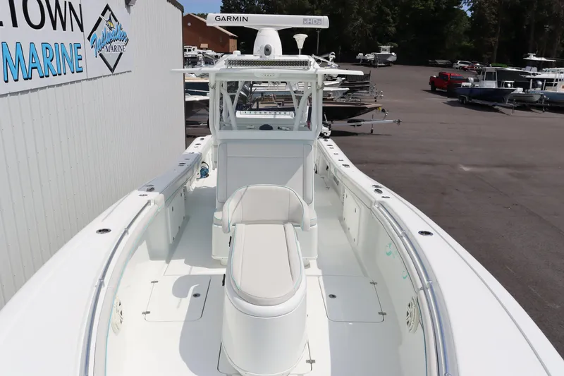 Slide: The Image of 2018 Yellowfin 36 Offshore boat at marina, featuring spacious deck and advanced navigation equipment. - 7