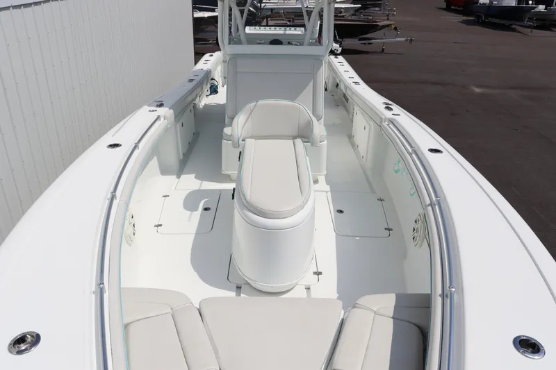 Slide: The Image of 2018 Yellowfin 36 Offshore boat interior with white seating and spacious deck. - 9