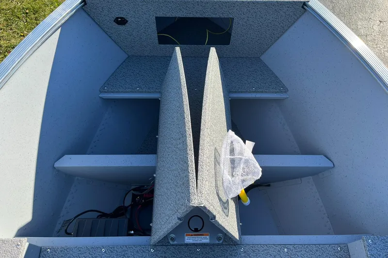 Slide: The Image of 2025 Lund 1600 Fury Tiller boat interior with storage compartments and fishing net. - 11