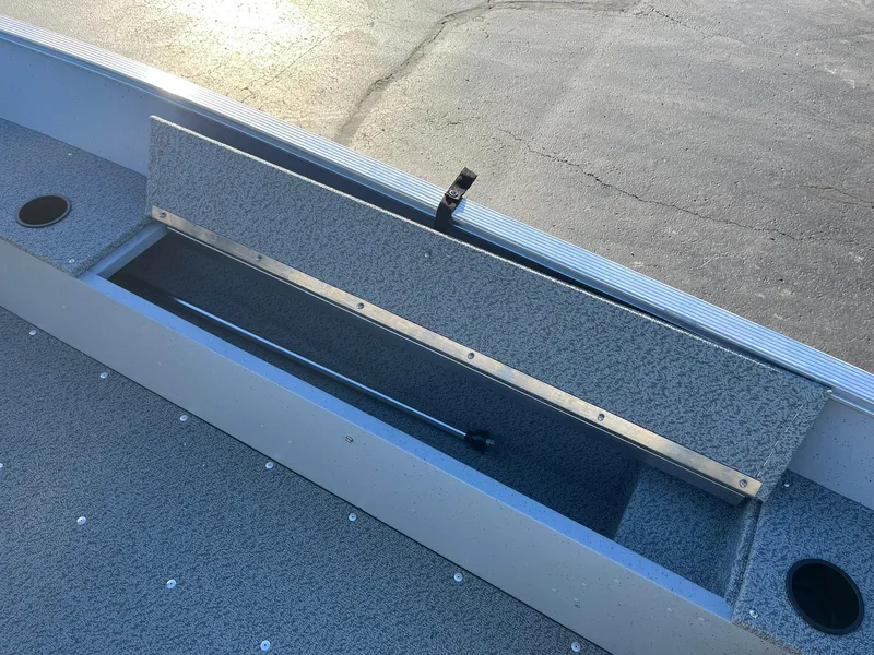 Slide: The Image of 2025 Lund 1600 Fury Tiller boat interior with storage compartment open. - 16